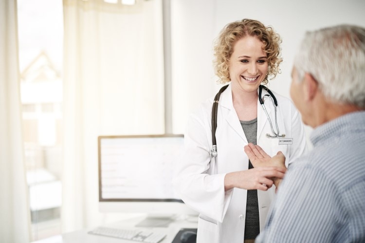 Female doctor with client checking on Blood Glucose Levels 